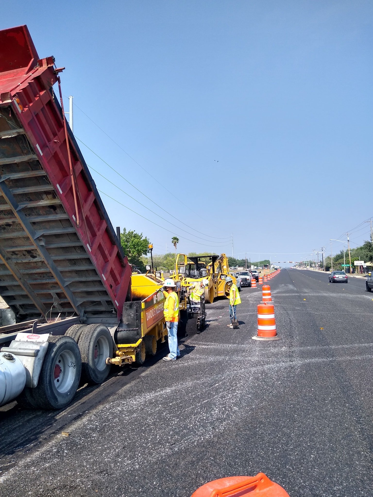 Asphalt paving crew on TxDOT-certified road project — South Texas